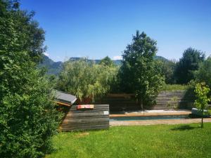 a garden with a pool and trees in the background at Les Gîtes Vu d'Ici in La Chapelle-en-Vercors