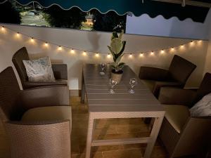 a table with a potted plant and lights on a patio at Studio Lido 10 in Lido delle Nazioni