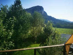 a view of a field with a mountain in the background at Les Gîtes Vu d'Ici in La Chapelle-en-Vercors +3 photos