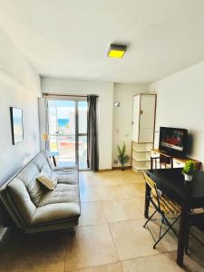 a living room with a couch and a table at El Cairo 10 in Puerto Madryn
