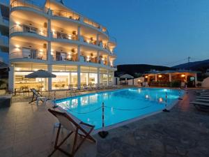 a large building with a swimming pool in front of it at Olympion Melathron in Platamonas