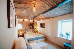 a bedroom with a bed and a couch in a room at Country house Harmonia in Modra