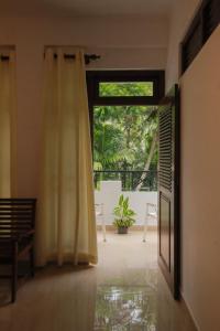 an open door to a room with a patio at Renuka Inn in Kandy