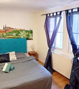 a bedroom with a bed and a painting on the wall at Prague centrum house in Prague +42 photos