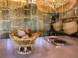 a basket of nuts sitting on a table with chandeliers at 2BR 2Bath Eco Home Bungalow, Bangrak Beach, Koh Samui in Amphoe Koh Samui