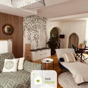 a living room with a couch and a table at H3 Charmante maison sur la Vilaine près du Château in Vitré