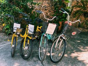a group of three bikes parked next to each other at โรงแรมเพิ่มพูล 1 in Nan