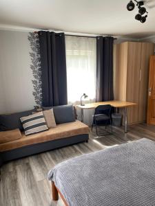 a living room with a couch and a table at Brīvdienu apartaments Melnsilā in Melnsils