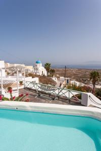 a swimming pool with a view of the ocean at Cavern House Anthea in Éxo Goniá