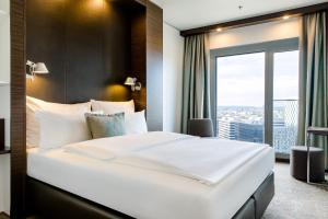 Ein Bett oder Betten in einem Zimmer der Unterkunft Motel One Wien-Hauptbahnhof