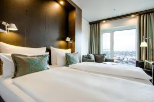 Ein Bett oder Betten in einem Zimmer der Unterkunft Motel One Wien-Hauptbahnhof