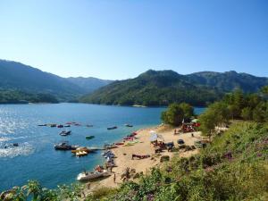 a group of people on a beach on a lake at Os Girassóis da Carla in Braga