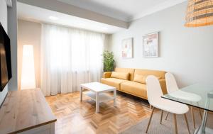 a living room with a couch and a table at EnjoyGranada RECOGIDAS HOMES in Granada