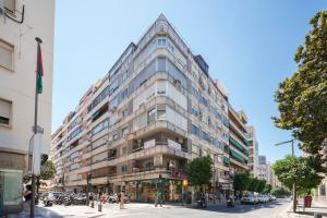 a large building on the corner of a city street at EnjoyGranada RECOGIDAS HOMES in Granada