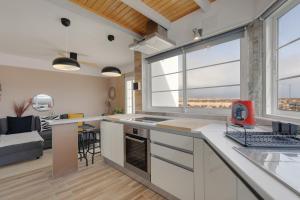 a kitchen and living room with a large window at Las Arenas Family in Costa Calma