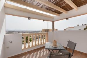 a patio with a table and chairs on a balcony at Las Arenas Family in Costa Calma