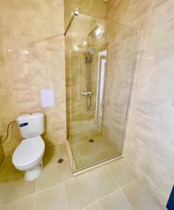 a bathroom with a shower and a toilet at Majestic Villas Pomorie Park in Sarafovo +10 photos