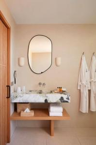 a bathroom with a sink and a mirror at Hôtel de La Plage in Biarritz