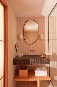 a bathroom with a sink and a mirror at Hôtel de La Plage in Biarritz