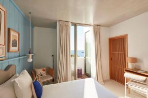 a hotel room with a bed and a balcony at Hôtel de La Plage in Biarritz