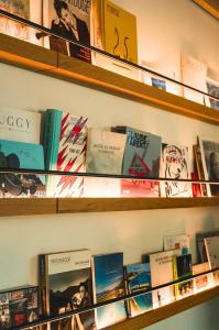 a shelf full of books in a bookstore at Hôtel de La Plage in Biarritz