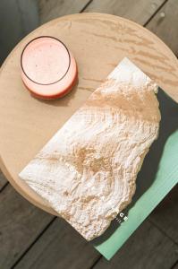 a wooden table with a plate of food on it at Hôtel de La Plage in Biarritz