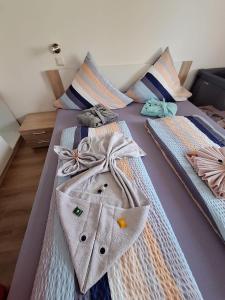 a couple of beds with ties on them at App 342 gemütlich und mit Weitblick in Braunlage +29 photos