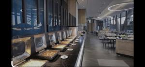a buffet line in a restaurant with plates of food at Capitol on the Park in Johannesburg