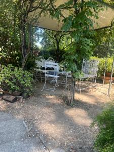 a group of white chairs under a canopy at Hotel Villa Liana in Florence