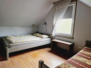 a bedroom with two beds and a window at Guest House Podnieki in Ventspils +70 photos