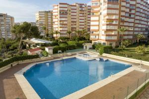 an overhead view of a large swimming pool with tall buildings at Bloque 76 in Torrox