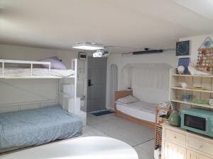 a bedroom with two bunk beds and a microwave at Cheongnyangni Star Whale House & Rooftop in Seoul