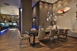 a dining room with a table and chairs at Motel One Prague-Florentinum in Prague