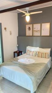 a bed with a plate on it in a bedroom at Paraiso Mar in Búzios +37 photos