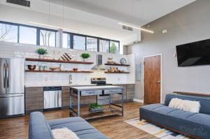 a living room with a couch and a kitchen at Avenue B846 2br, With A Pool, Gym, Parking in Philadelphia