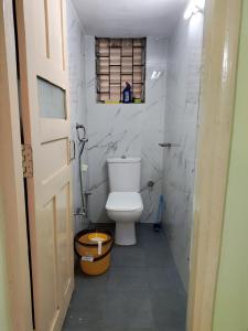 a bathroom with a white toilet and a window at Serene Homestay in Panaji +12 photos