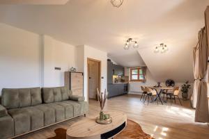 a living room with a couch and a table at Apartmán Manuel in Horní Planá