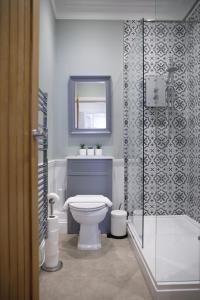 a bathroom with a toilet and a shower at Grove Apartment with Free on street Parking in Worthing