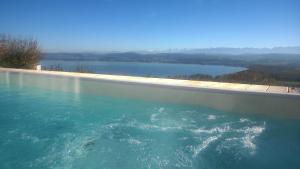 a swimming pool with a view of a body of water at Swiss Borzoi House in Bellerive