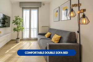 a living room with a couch and a lamp at Bonomi 7 - AFFITTICA in Milan