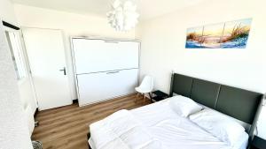Postel nebo postele na pokoji v ubytování Appart front de mer, 5e étage