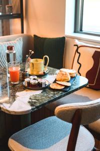 a table with a tray of food and a cup of coffee at Hôtel de La Plage in Biarritz