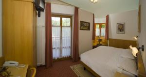 Postel nebo postele na pokoji v ubytování Hotel Waldheim Belvedere