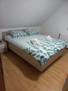 a bed with two towels on it in a bedroom at FAMILY HOUSE Pri Kovaču in Soča