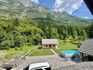 an aerial view of a house with a pool and mountains at FAMILY HOUSE Pri Kovaču in Soča