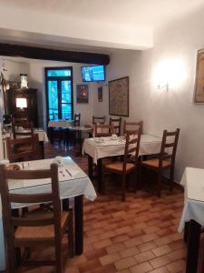 a dining room with tables and chairs in a restaurant at Hôtel Central in Digne-les-Bains