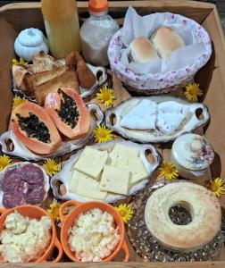 a tray filled with different types of cheese and other foods at Rancho das Neves - Rancho Queimado - SC in Rancho Queimado