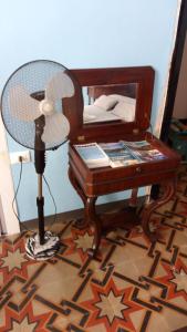 a desk with a fan next to a bed at Sentieri in Levanto +7 photos