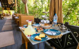 a table with blue plates of food on a patio at The Lemonary Marrakech in Marrakech