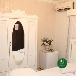 a white cabinet with a mirror in a room at Hotel Gaucha in Guaíra +61 photos